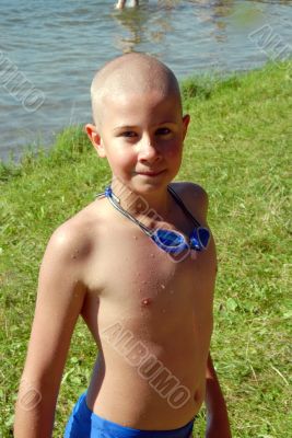 boy in googles on the beach