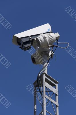 CCTV camera against blue sky