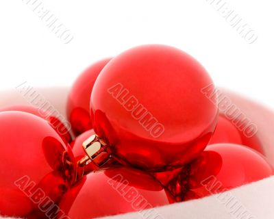 Red christmas balls in fur hat. Close-up