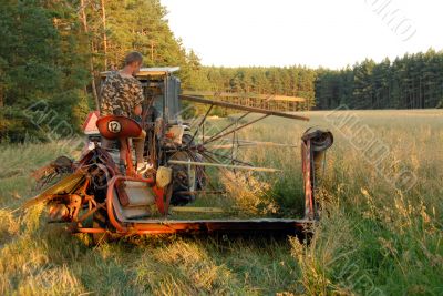 man operates an old tractor