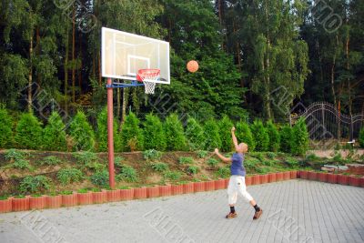 teen plays basketball