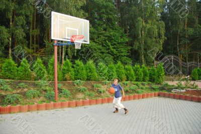 teen plays basketball