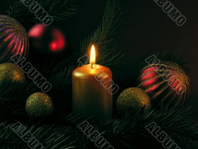 Christmas ornaments and burning candle