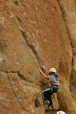 Climber on sheer rock face