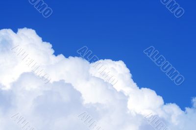 The blue sky and beautiful white clouds.
