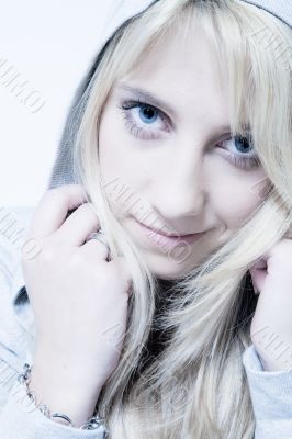 Studio portrait of friendly looking a long blond girl