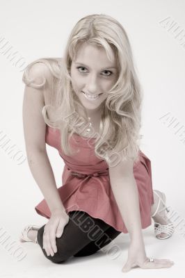 Studio portrait of a long blond girl sitting