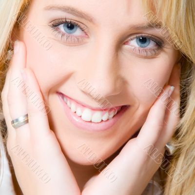 Studio portrait of a long blond girl smiling