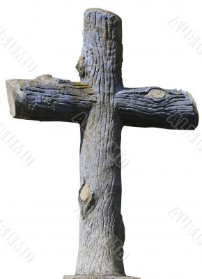 Isolated stony christian cross of wooden logs