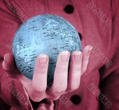 Globe in a girl`s hands