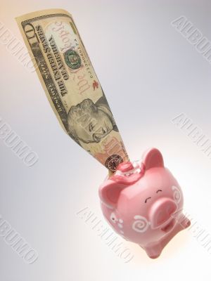 piggy bank and ten dollars