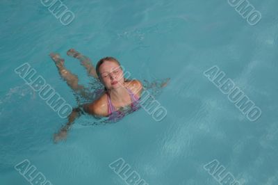 Beautiful young woman in the pool