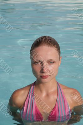 Beautiful young woman in the pool