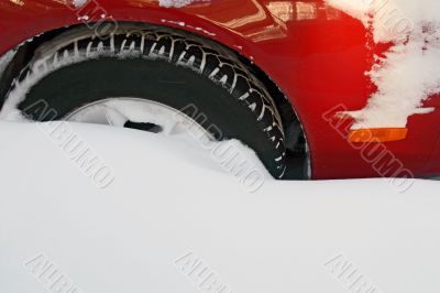 Car wheel stuck in the deep snow