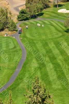 Golfers on bright green fairway