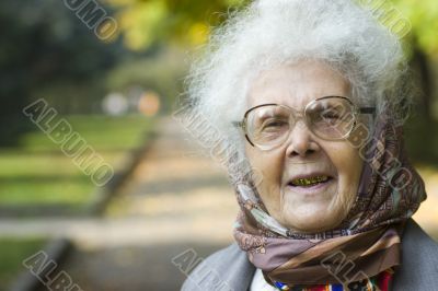 Laughing elderly woman in park