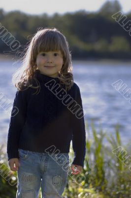 Girl on the bank of a river