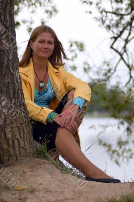 Woman sitting near the tree