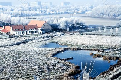 Winter landscape high view over a farmhouse