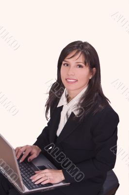 Smilling brunette working on a laptop