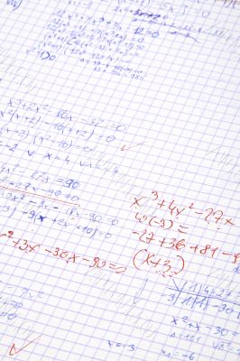 hand written maths calculations with teacher`s corrections in re