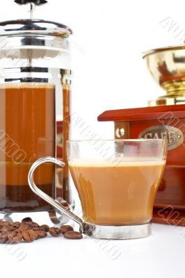 Cup, grinder, coffee pot and beans