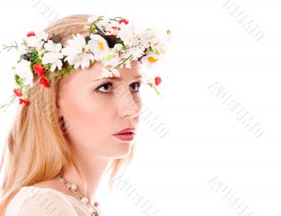 Pretty spring girl with wreath on head looking forward