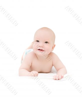 Funny little baby lying on white bed