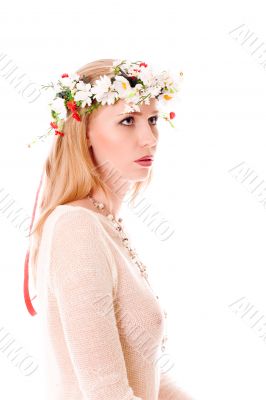 Pretty spring girl with wreath on head looking forward