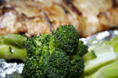 Close-up of baked pink salmon served with broccoli