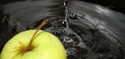 Green apple in dark water