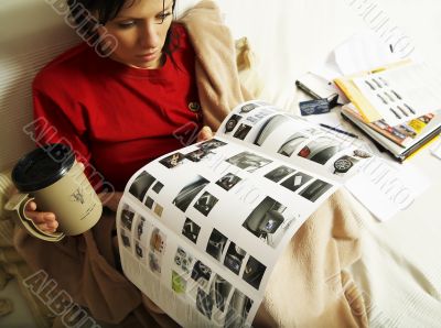 a young woman is reading a new car booklet
