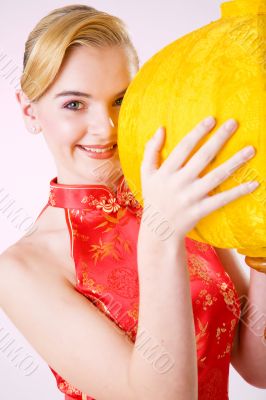 smiling girl holding a yellow chinese lantern
