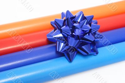 Colorful wrapping paper and a gift bow