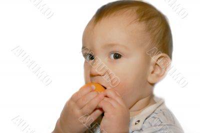 baby boy eatng orange