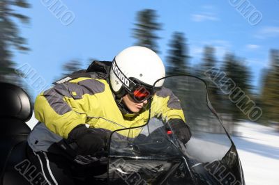 Teen boy on snowmobile