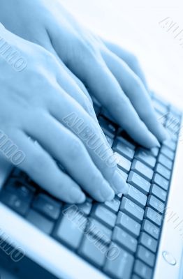 Typing on a laptop