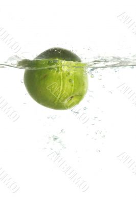 Green apple in water