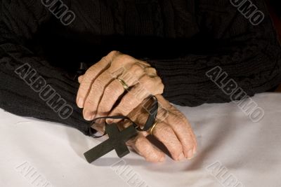 Old hands with black cross