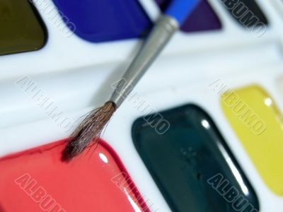 Multicolored aquarelle with paintbrush