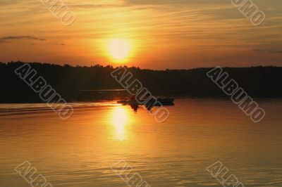 kayakers against summer sunset