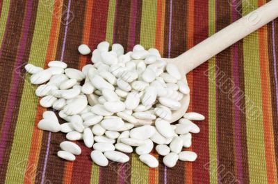 White beans on a cooking spoon