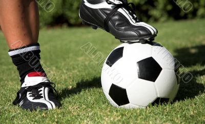 Soccerboot on top of soccer ball