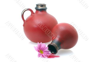 two wine jugs with a flower