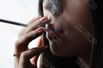 Young woman smoking a cigarette.