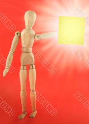 wooden figure with empty note