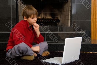 Boy at Fireplace on Computer