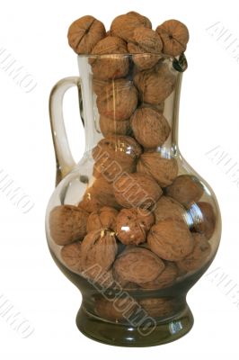 Handful of walnuts in a glass decante