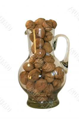 Handful of walnuts in a glass decante