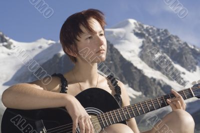 Girl playing guitar in the mountains 04